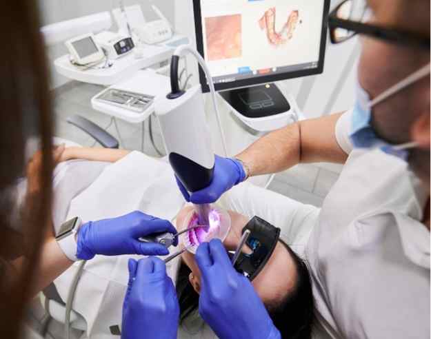 Dentist using iTero scanner on patient at Sana Dentistry